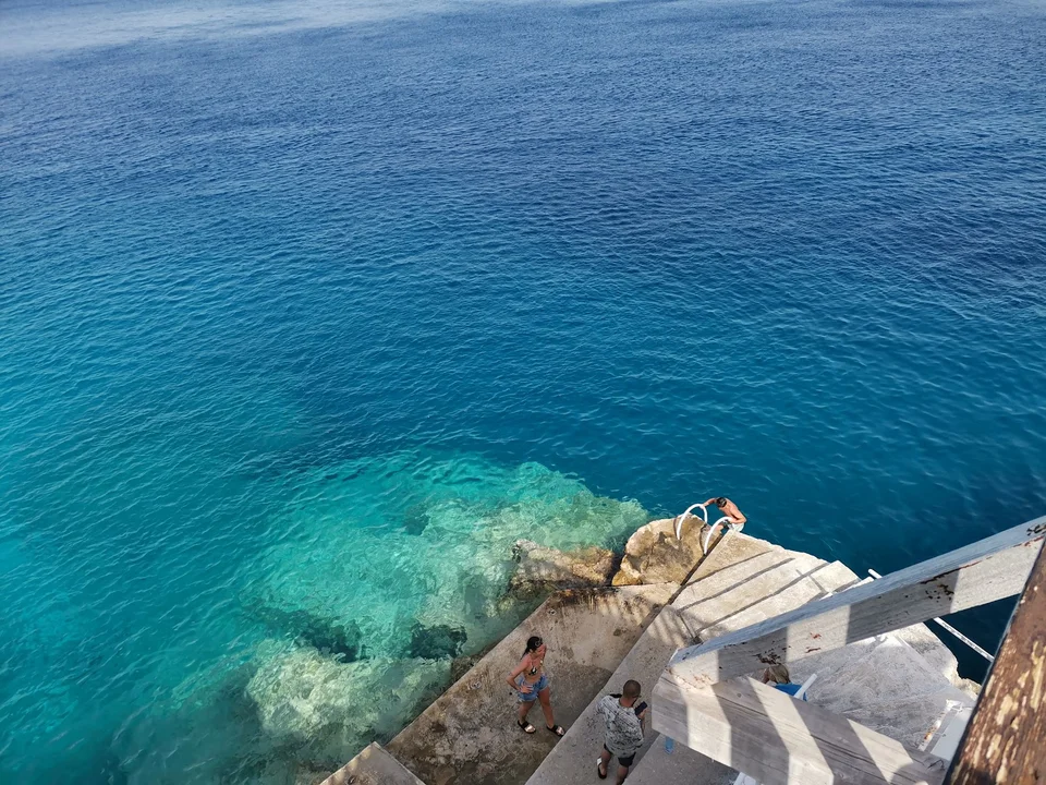 Swimming steps over clear blue water